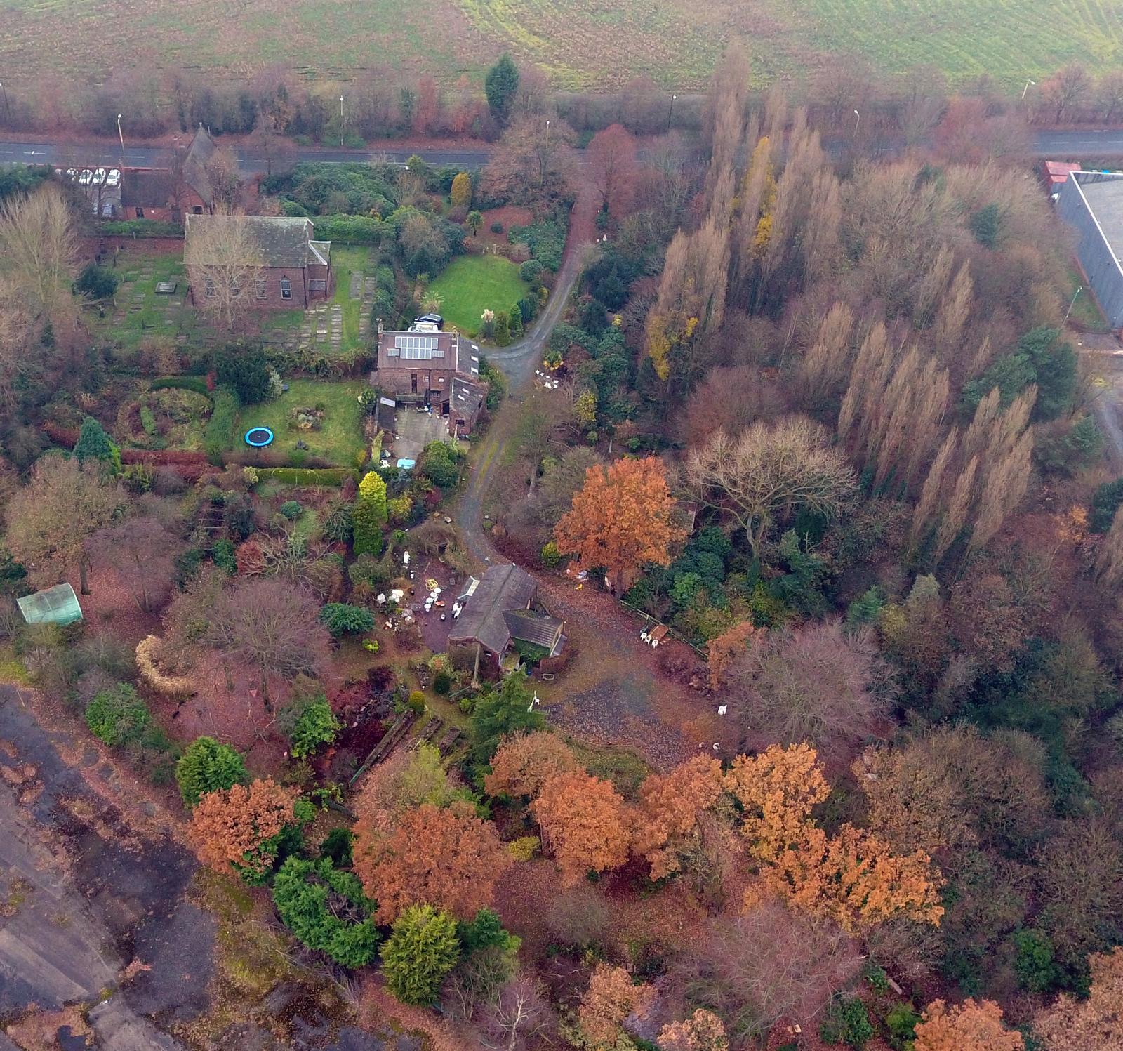 Aerial view of Vicarage Gardens in autumn, showing the old vicarage, chapel and surrounding woodland